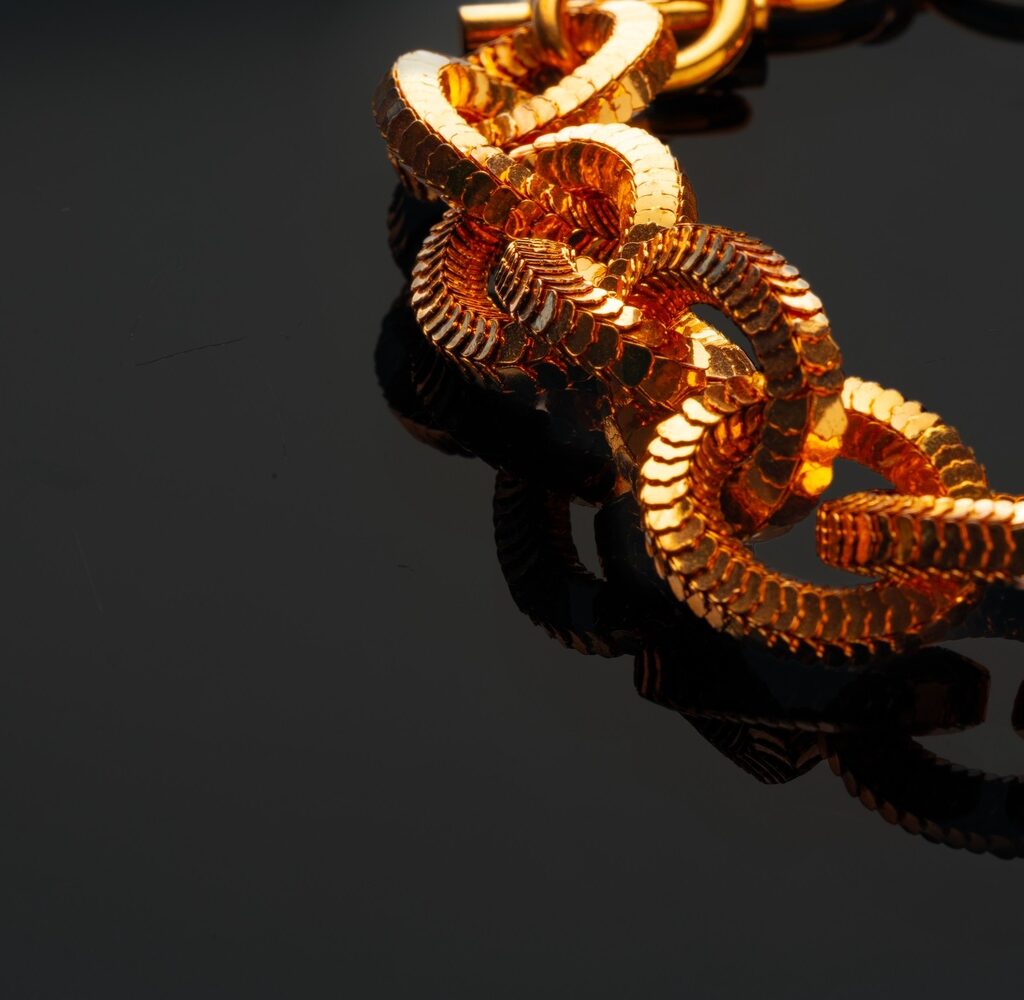 Golden Chain Necklace On Black Background With Ref VTJK95Q 1024x1000