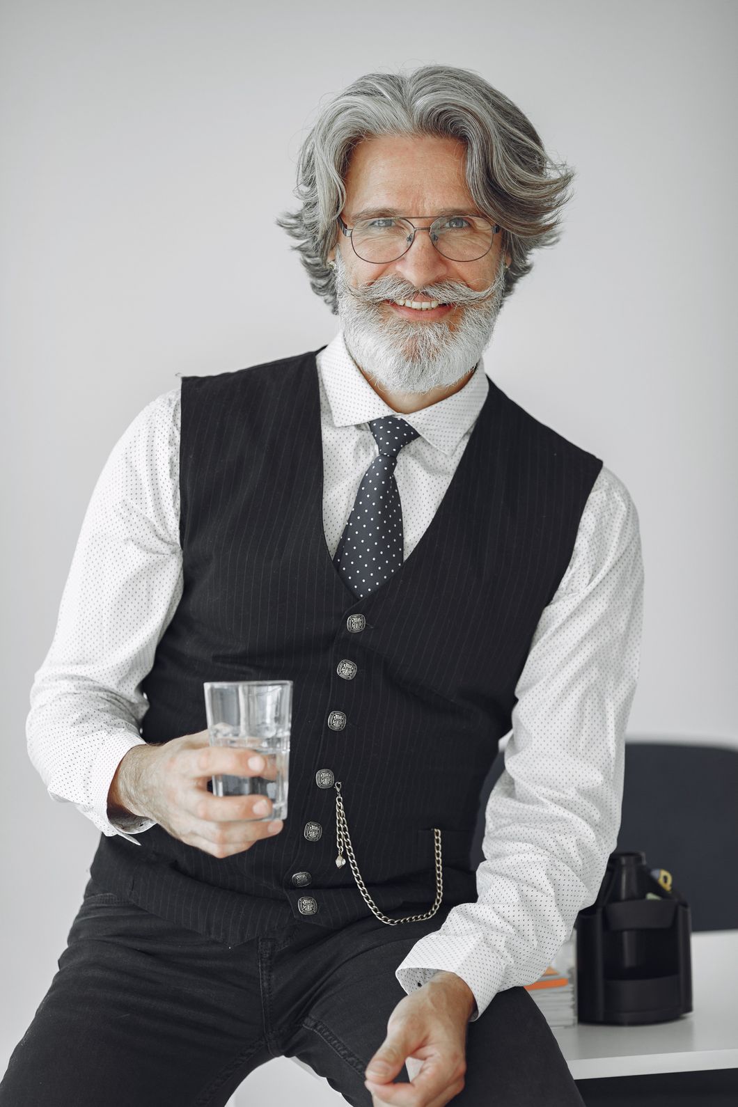 Handsome Old Businessman Sitting With Glass Of Wat 3Z3Z5K7