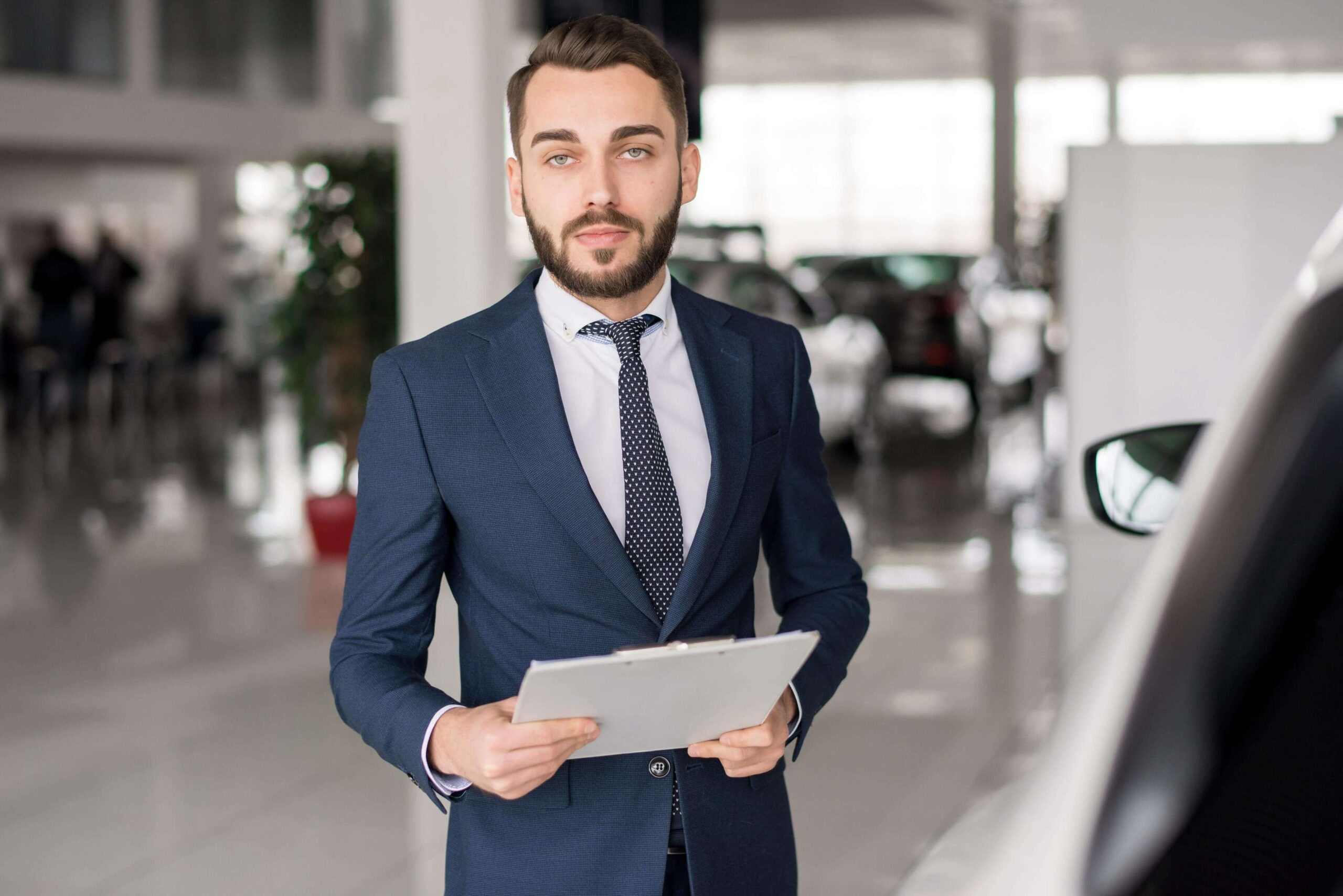 Successful Car Salesman In Showroom 7GV5SPK Scaled 1